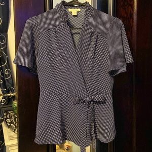 Woman’s navy blue and white polkadot blouse